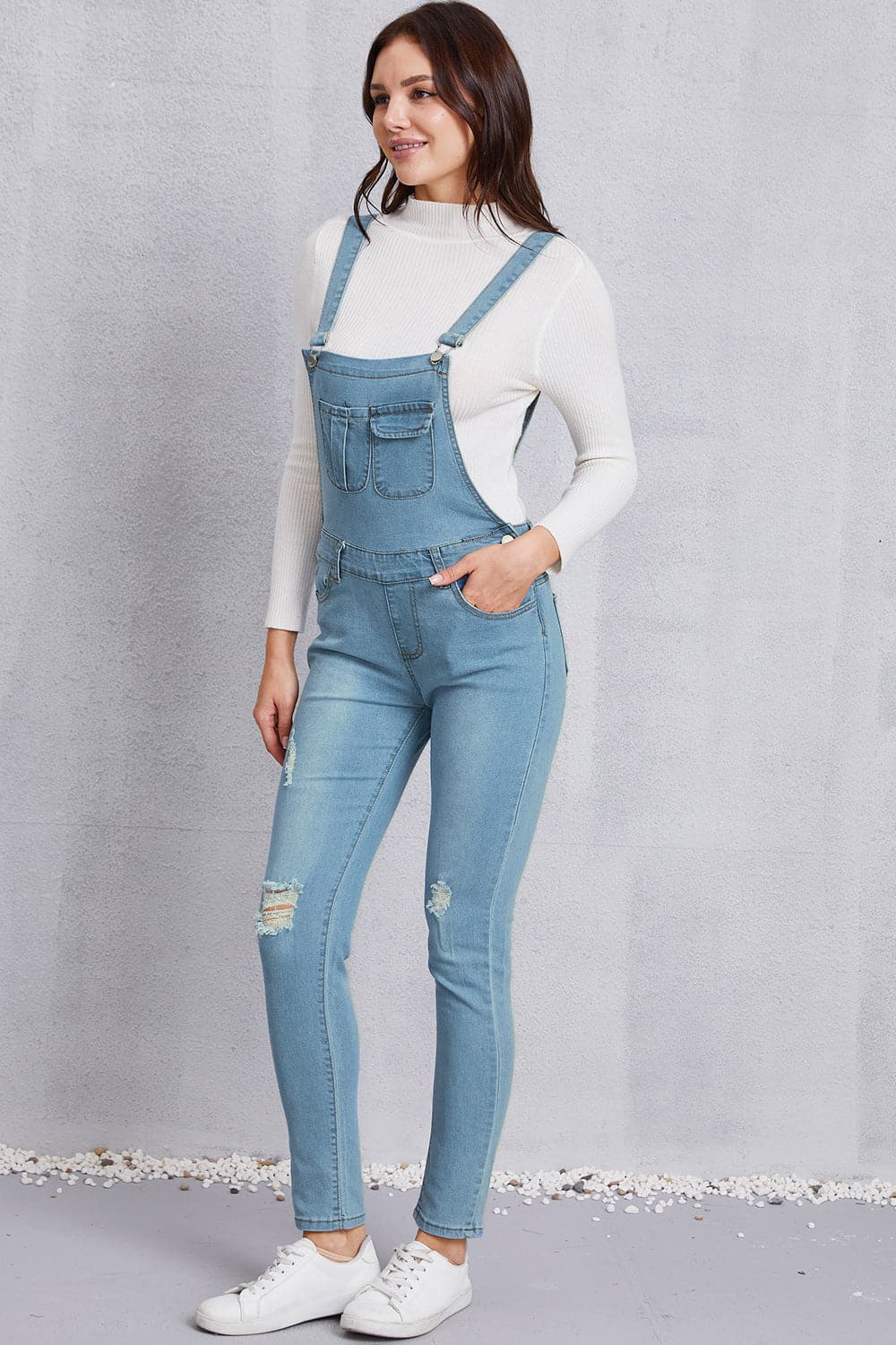 Distressed Washed Denim Overalls with Pockets.