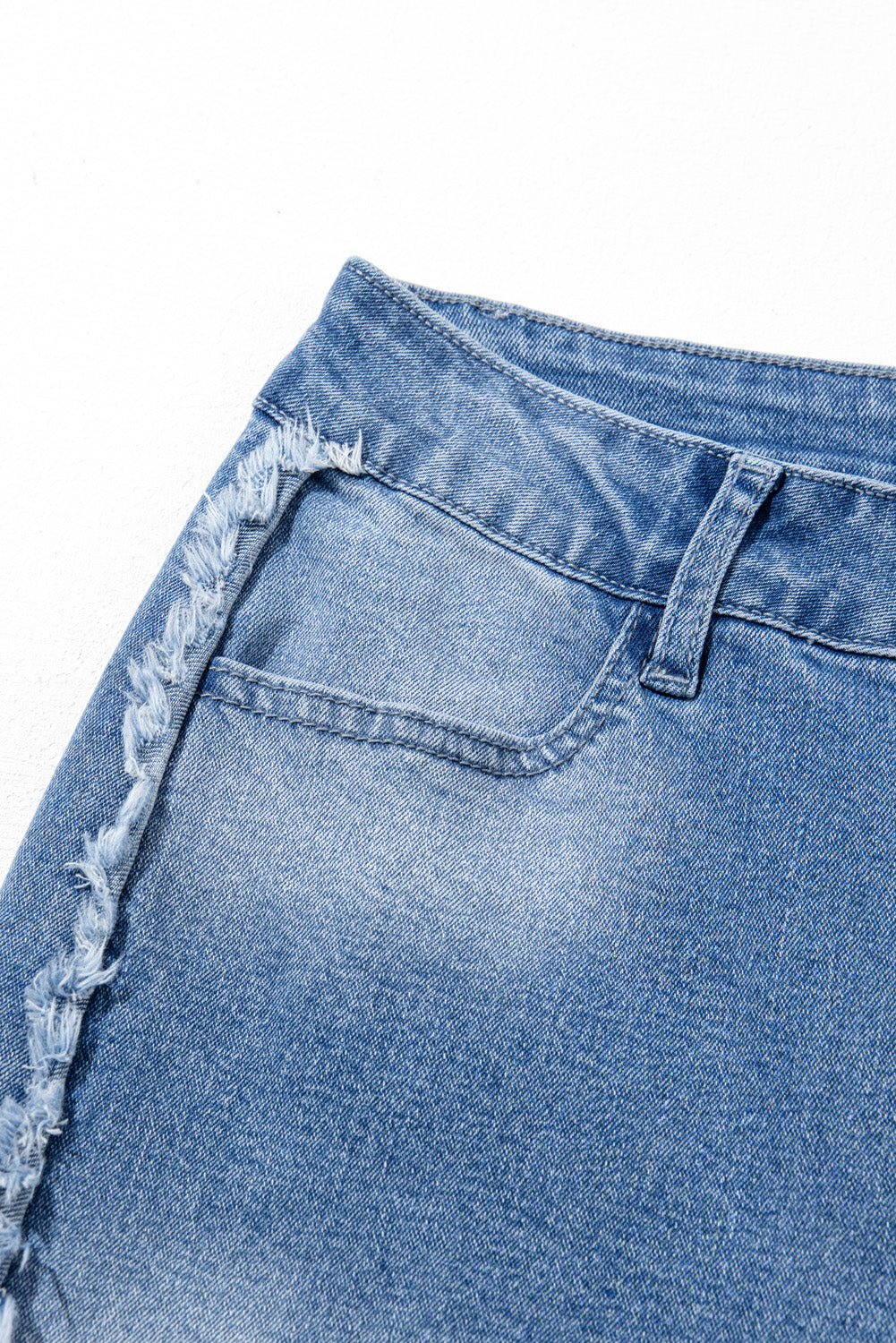 Vintage-inspired Beau Blue flared jeans with raw hem detailing