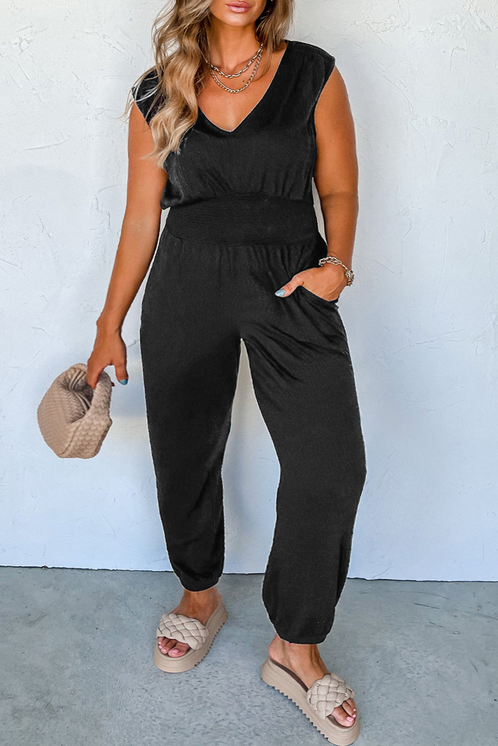 Elegant black plus size smocked jumpsuit with v-neck and sleeveless design