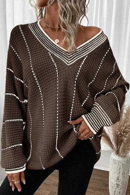 Vibrant striped v-neck sweater in brown with white stripes, slightly stretchy acrylic material.