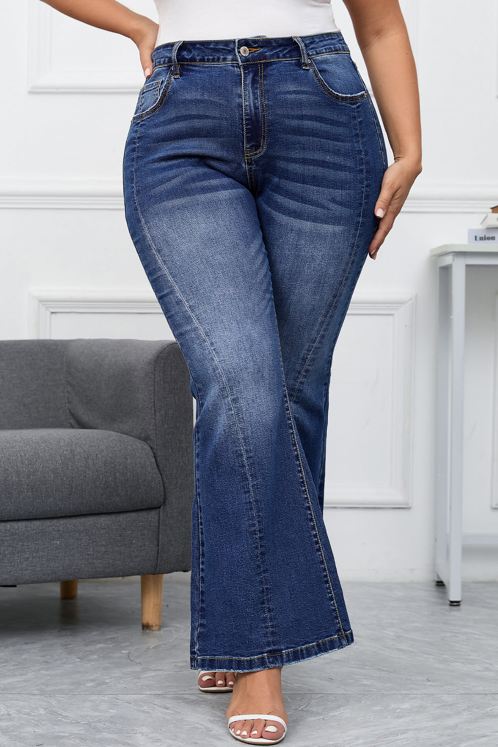 Vintage plus size blue flare jeans with high waist and bell bottom design.