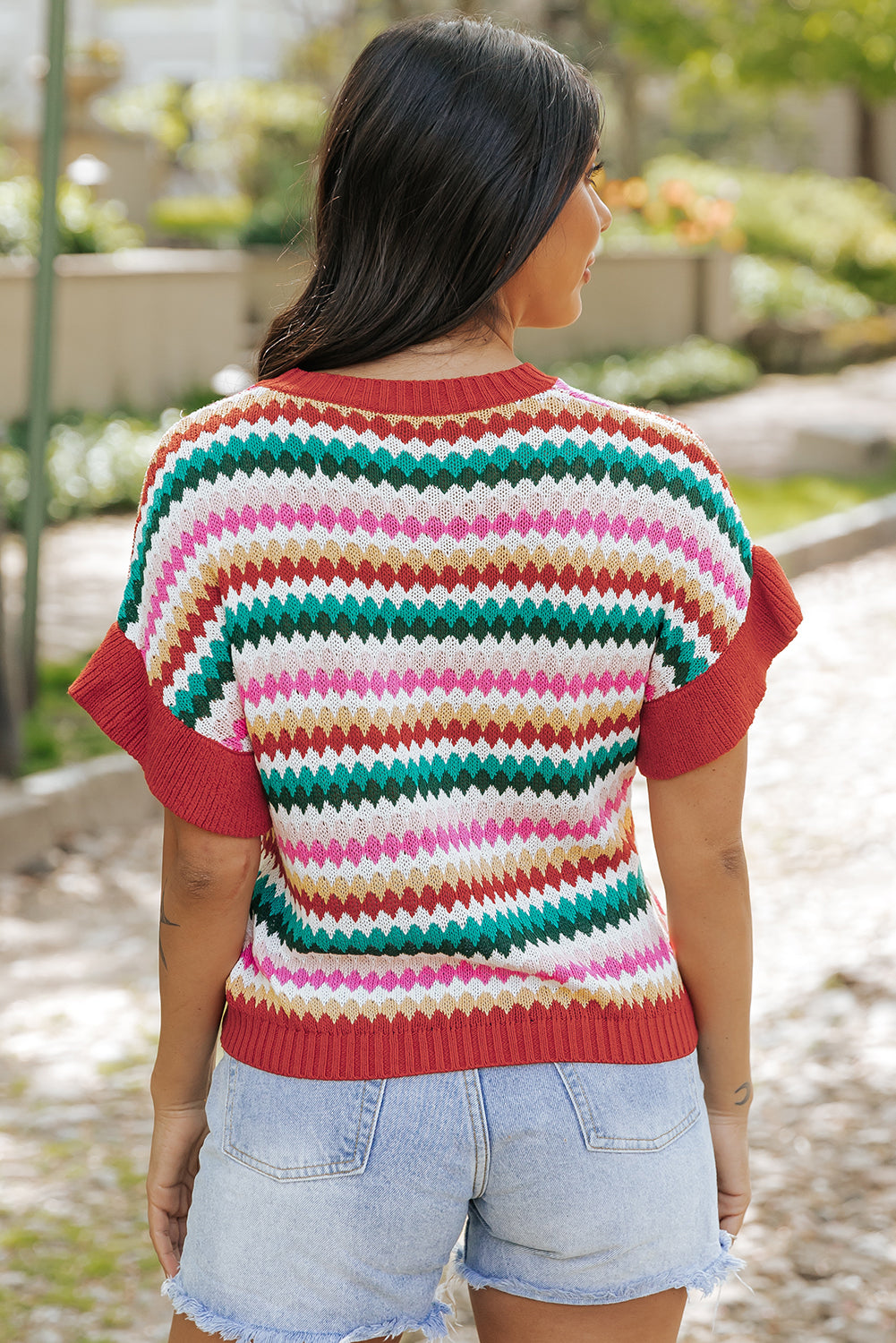 Colorful textured sweater with fiery red ruffle sleeves