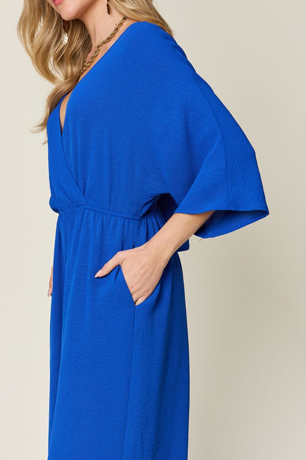 Double Take Full Size Surplice Wide Leg Jumpsuit with Pockets.