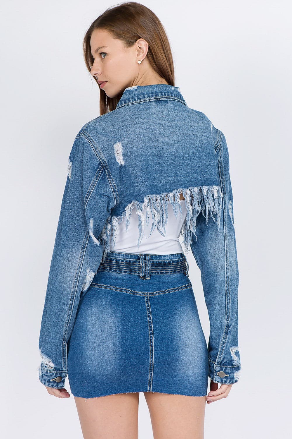 Chic cropped distressed denim jacket with frayed edges