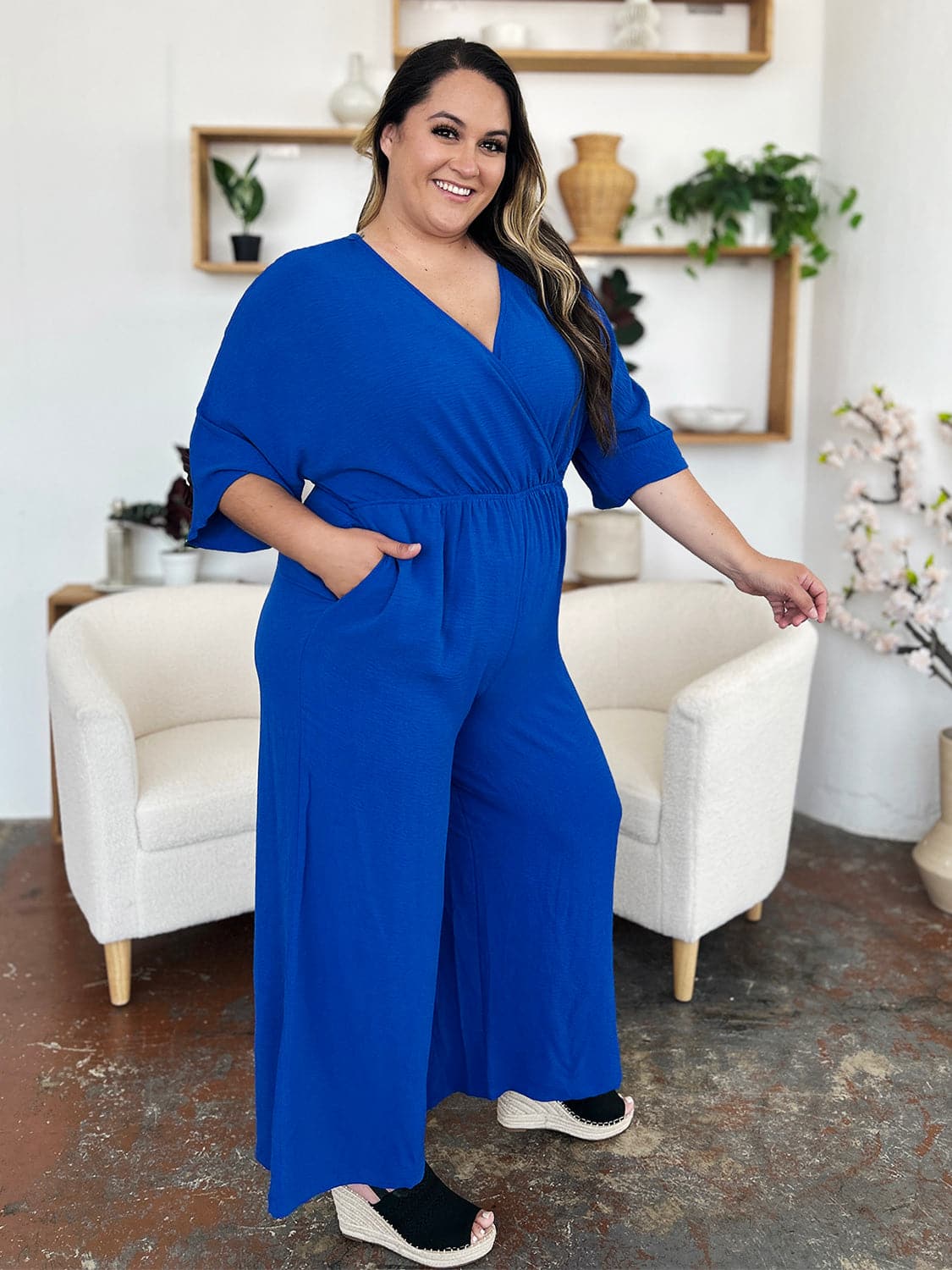 Double Take Full Size Surplice Wide Leg Jumpsuit with Pockets.