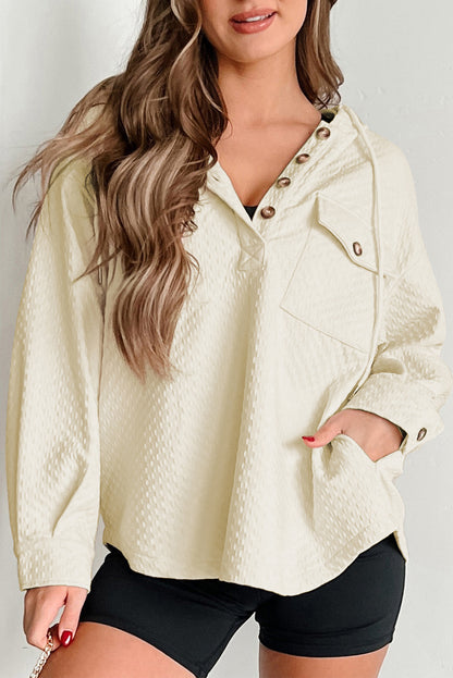 Chic apricot hoodie with buttoned neckline and functional pockets