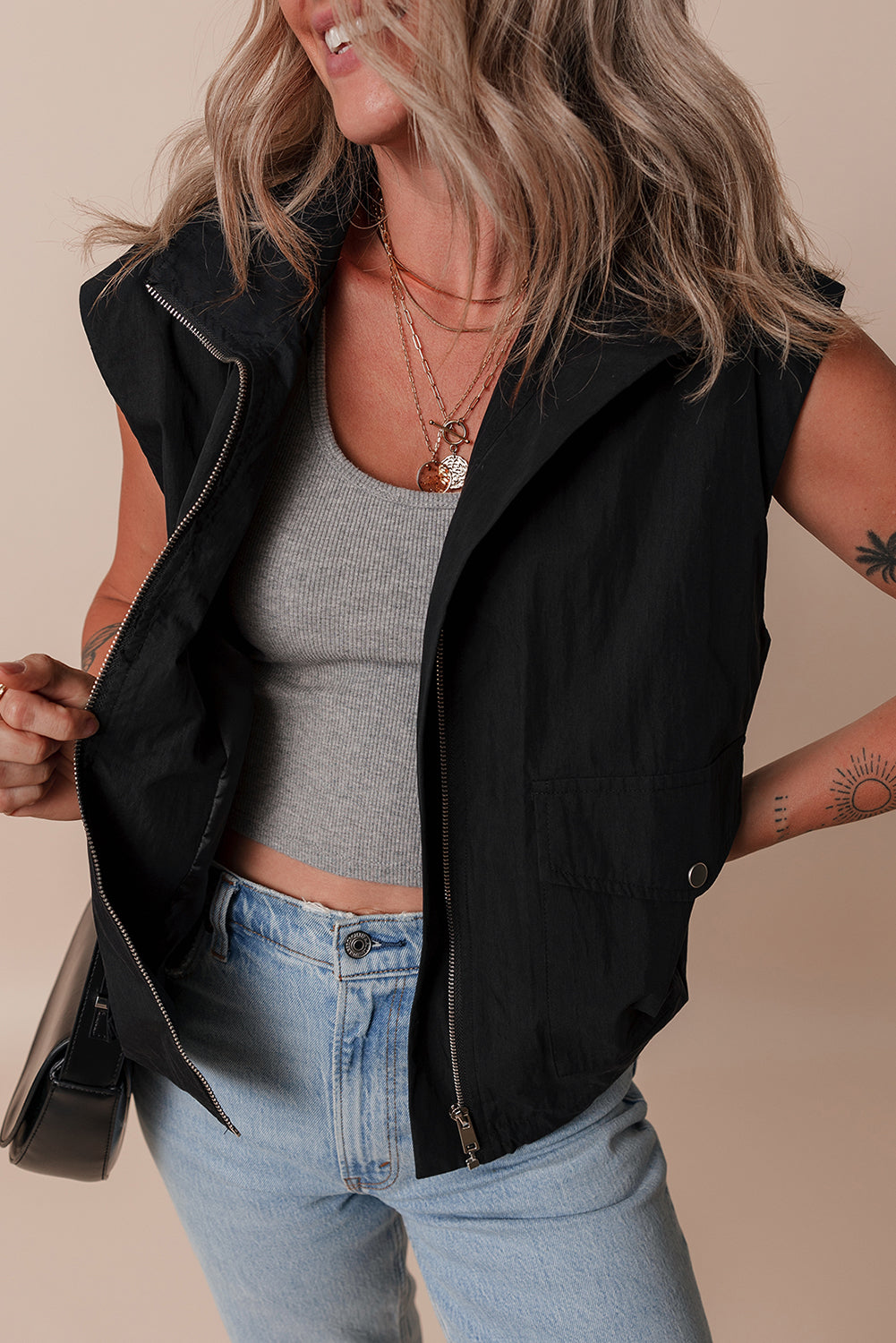 Chic black high neck vest with zip-up front and flap pockets