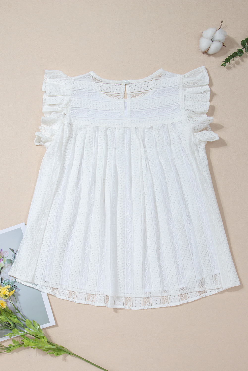 Lace-trimmed white flowy tank top with ruffled accents