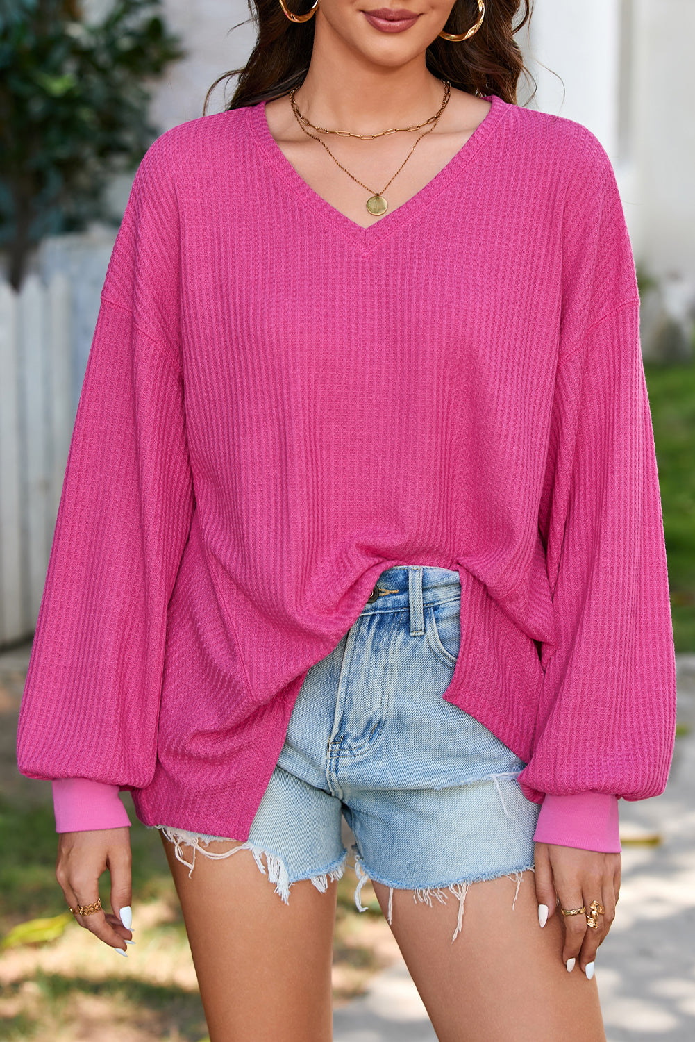 Chic bright pink waffle knit V-neck blouse with drop shoulders