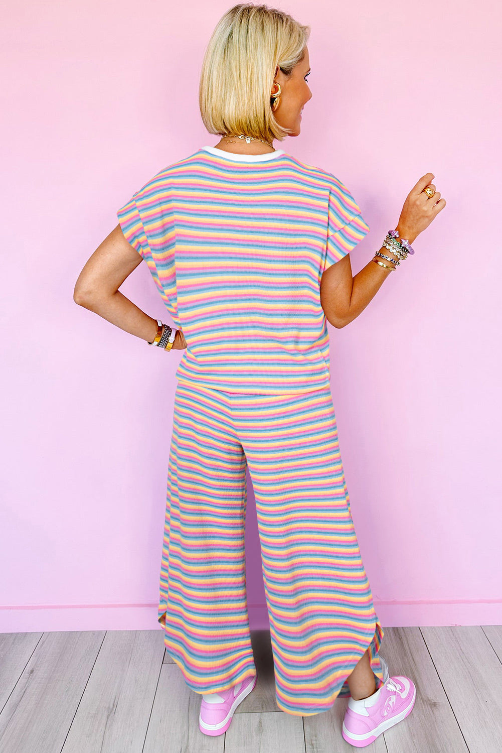 Chic pink striped rainbow tee and tasseled wide leg pants ensemble