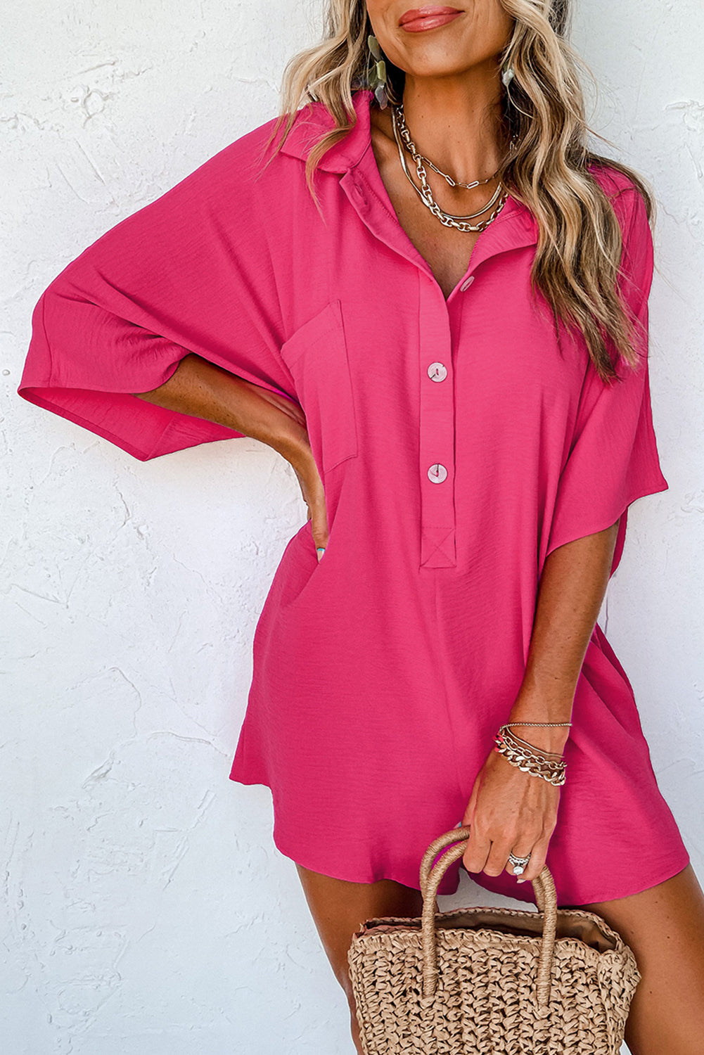 Vibrant pink oversized half-button collared romper for effortless style