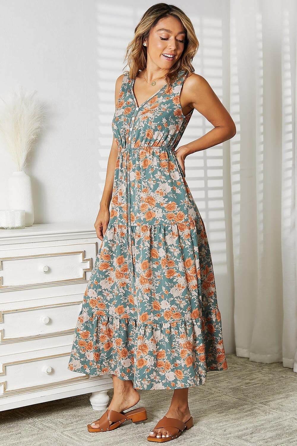 Floral V-Neck Tiered Sleeveless DressFloral V-Neck Tiered Sleeveless Dress
 Embrace the beauty of nature in our Floral V-Neck Tiered Sleeveless Dress. This stunning piece is designed to elevate your sumLove Salve -Neck Tiered Sleeveless Dressusa