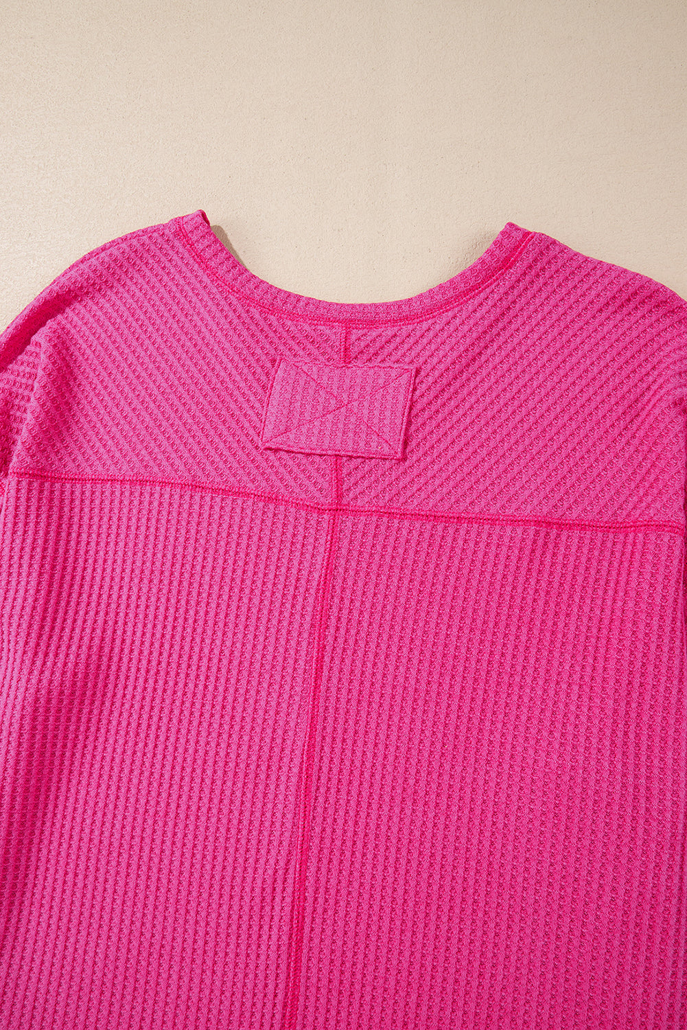 Chic bright pink waffle knit V-neck blouse with drop shoulders