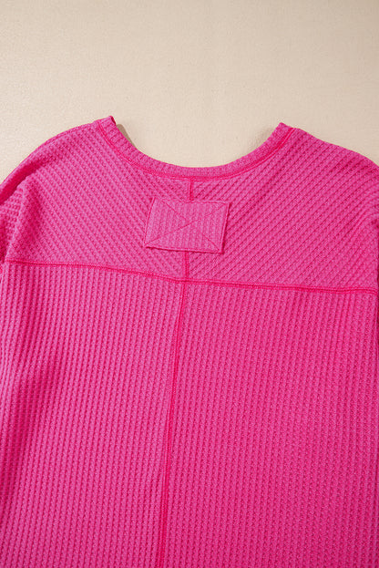 Chic bright pink waffle knit V-neck blouse with drop shoulders