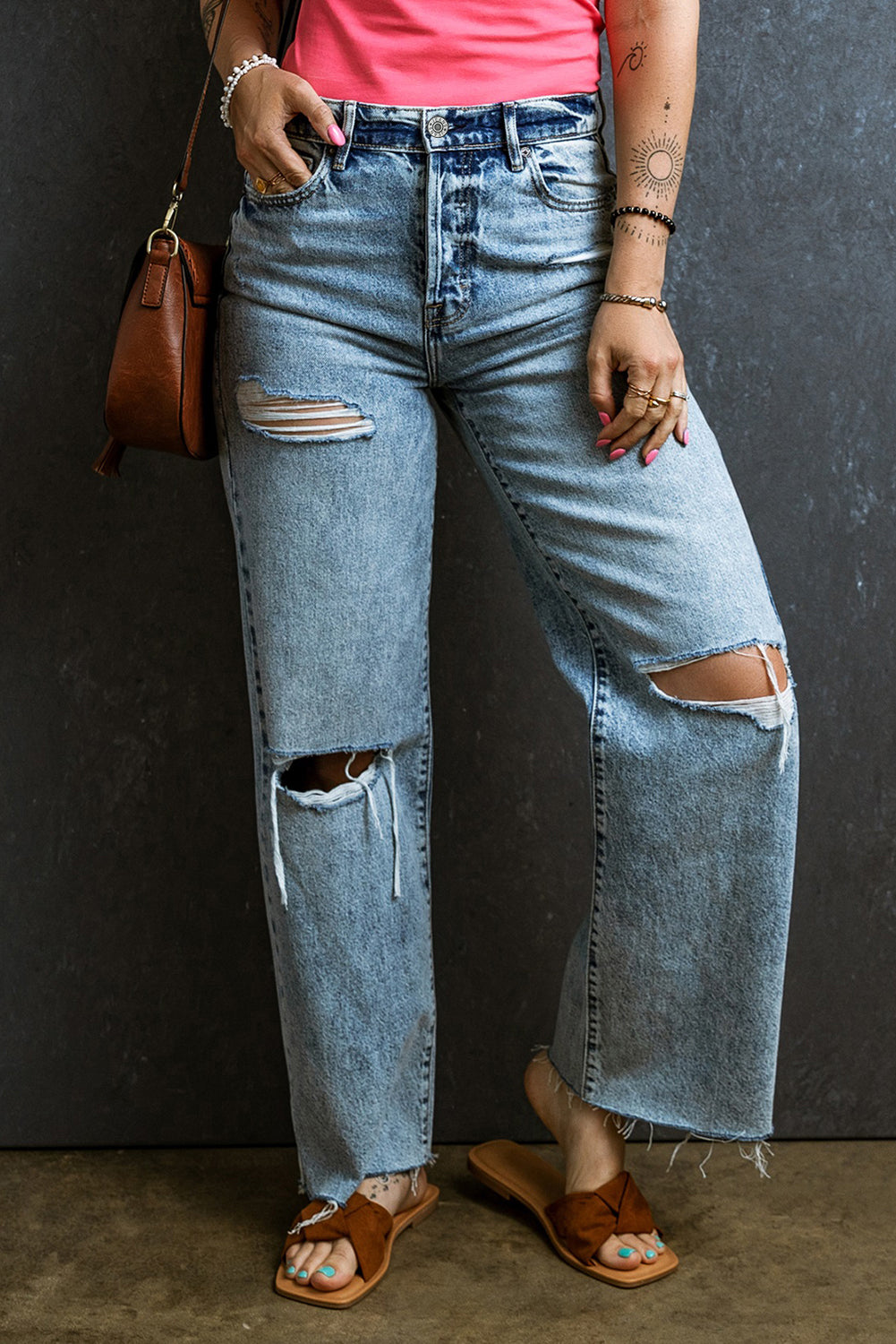 Trendy light blue distressed straight leg jeans with raw hem