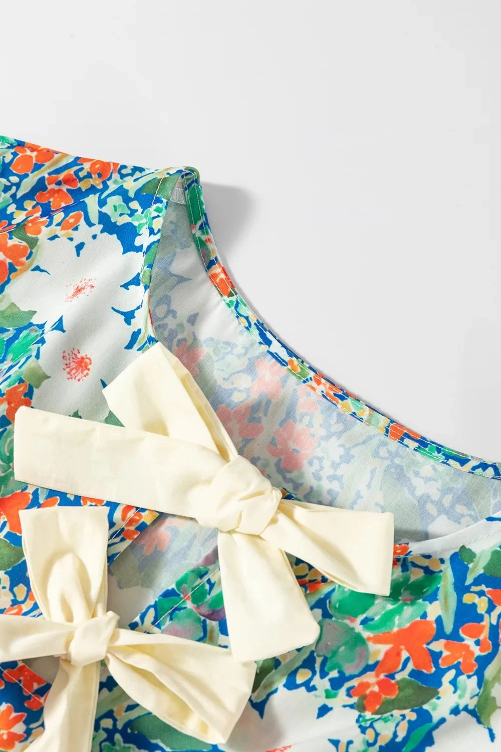 Floral Print Bow Applique Slit Sleeveless Peplum Blouse Simply Love