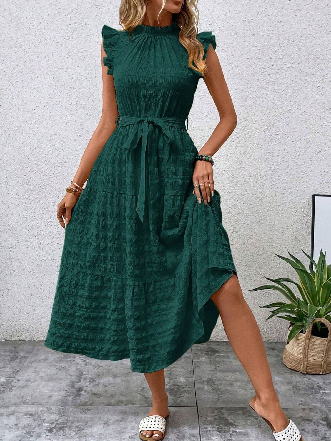 Ruffled cap sleeve midi dress in green with tie waist and tiered skirt, worn by a model.