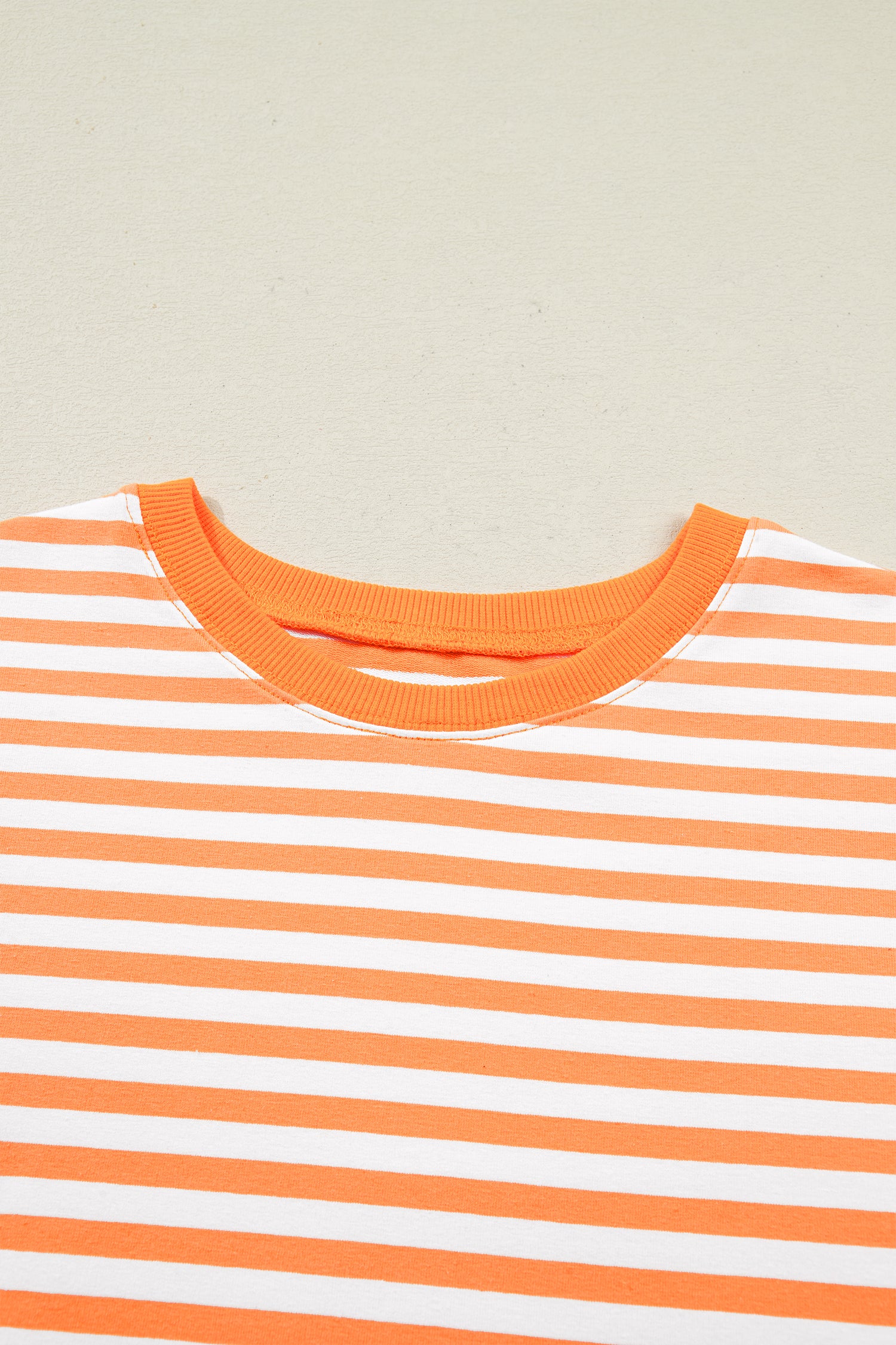 Orange striped patchwork top neckline and shoulder detail with three quarter sleeves