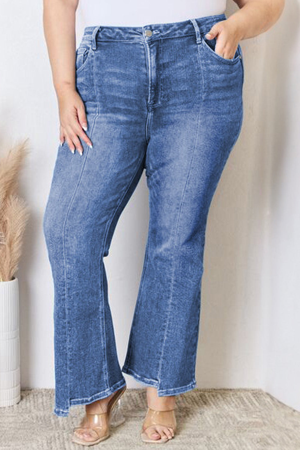 Stylish blue high-waist plus size flare jeans with exposed seam detail