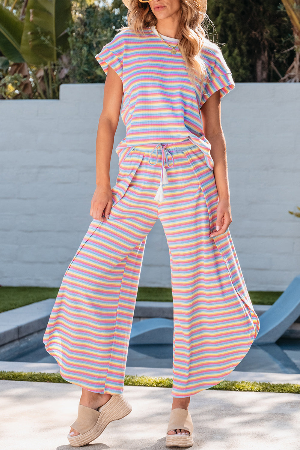 Chic pink striped rainbow tee and tasseled wide leg pants ensemble