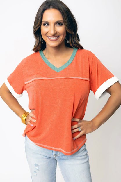 Grapefruit orange exposed seam V-neck tee with contrast trim