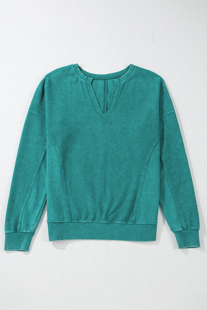 Skobeloff solid color notched neck drop shoulder sweatshirt with modern flair.