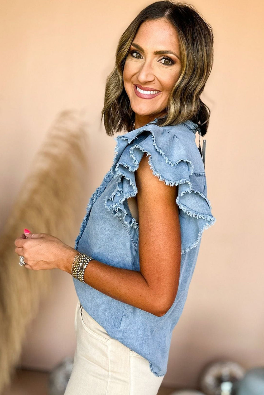 Chic ruffled denim top with button front and frayed hem