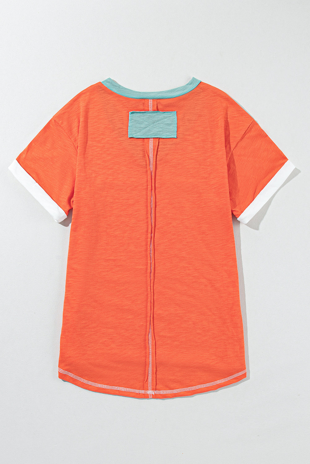 Grapefruit orange exposed seam V-neck tee with contrast trim