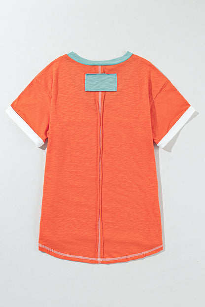 Grapefruit orange exposed seam V-neck tee with contrast trim