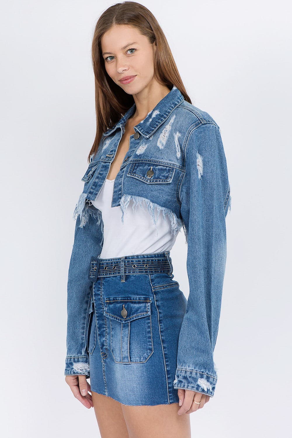 Chic cropped distressed denim jacket with frayed edges