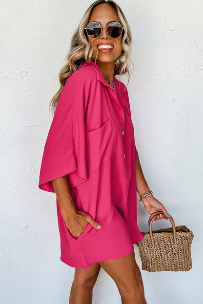 Vibrant pink oversized half-button collared romper for effortless style