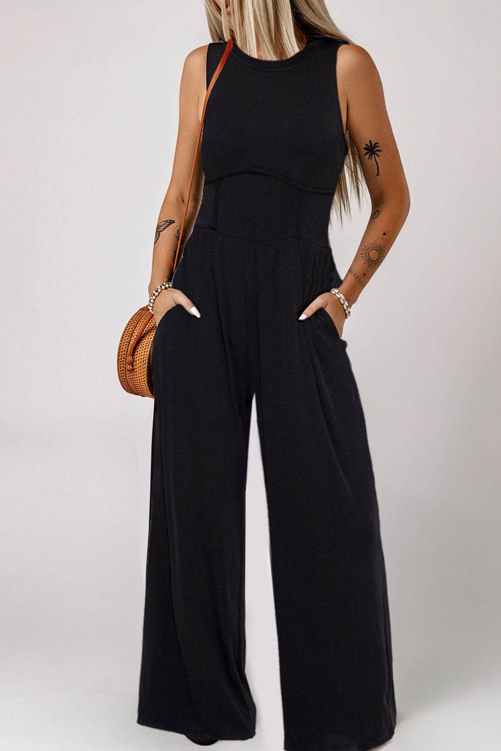 Chic black sleeveless jumpsuit with cinched waist and wide legs