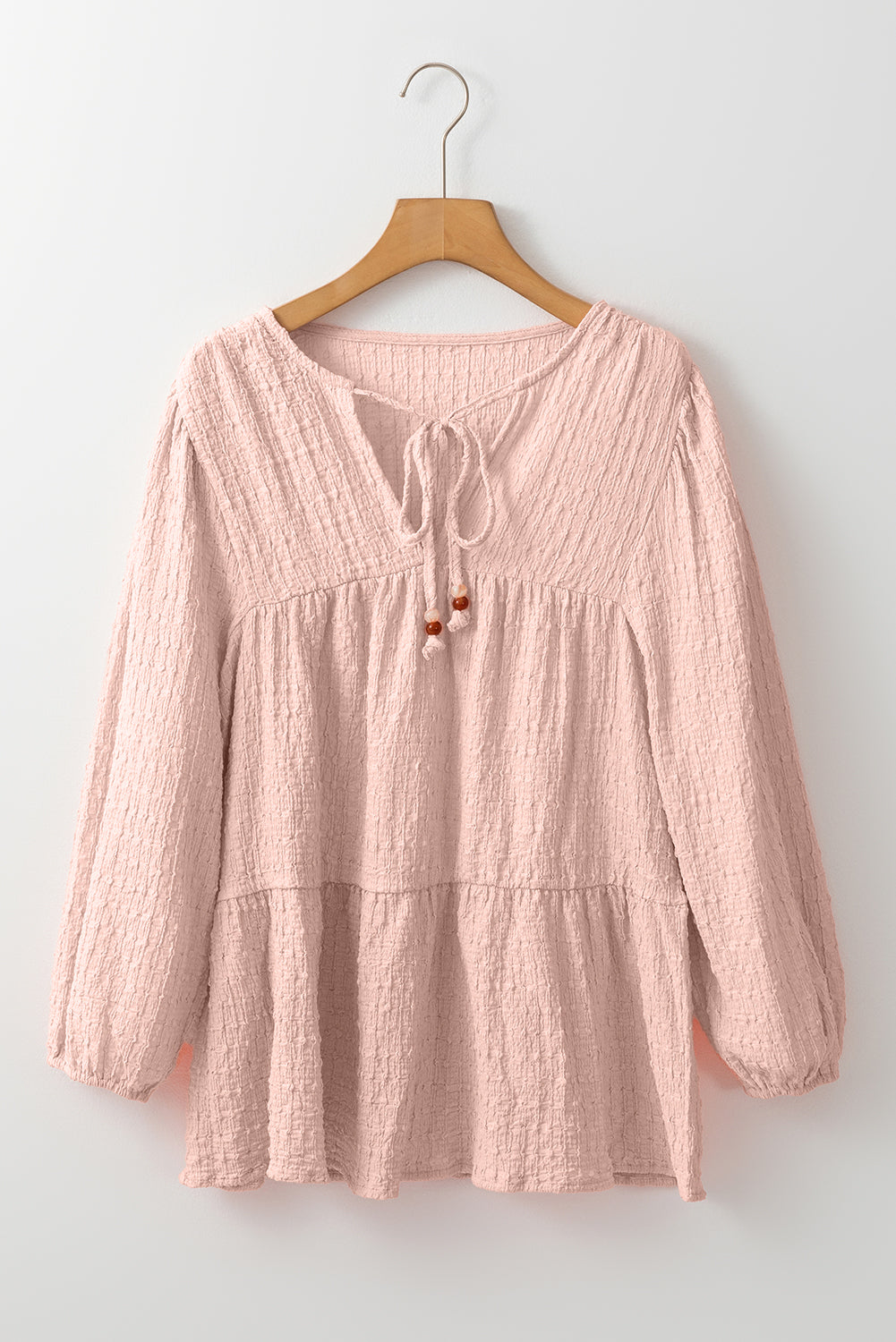 Chic tiered flowy blouse in soft pink texture