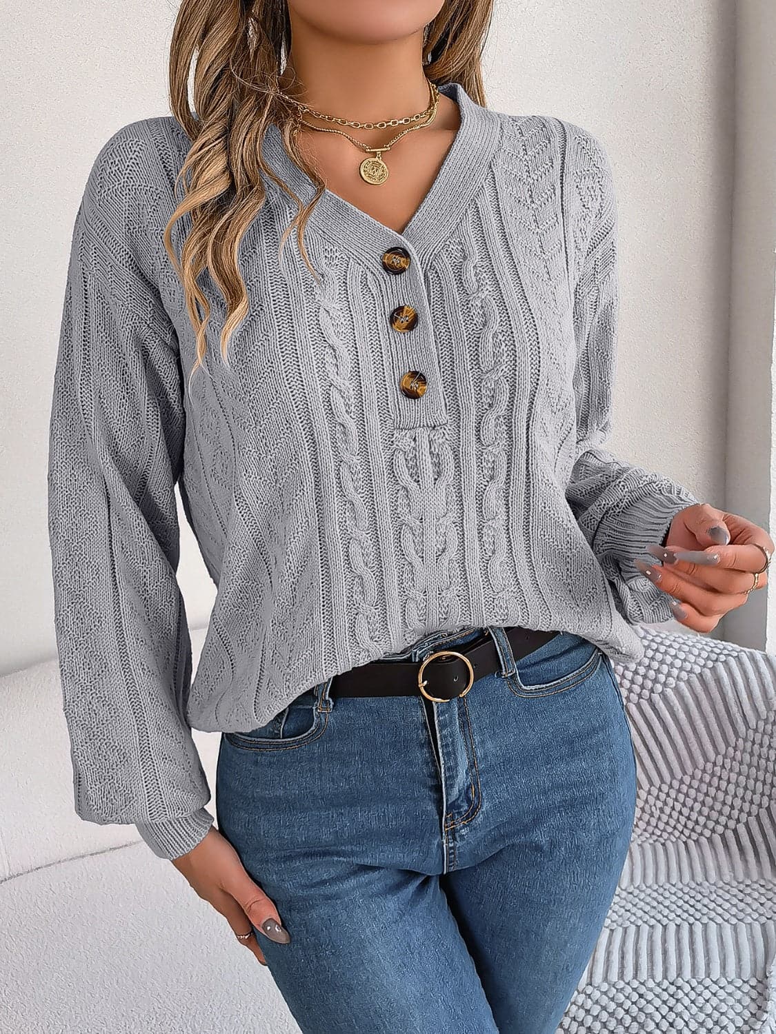 Chic cable-knit v-neck sweater with buttoned details