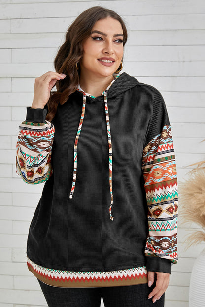 Stylish black hoodie with Aztec patchwork sleeves and drawstring detail