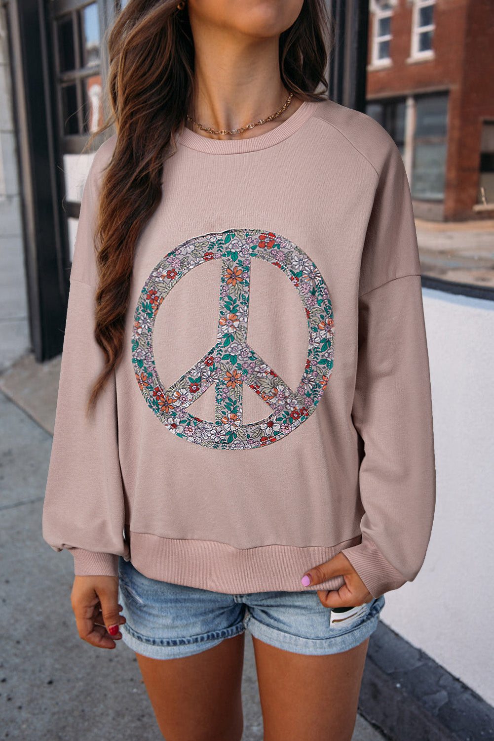 Floral peace symbol drop shoulder sweatshirt for a stylish and cozy look