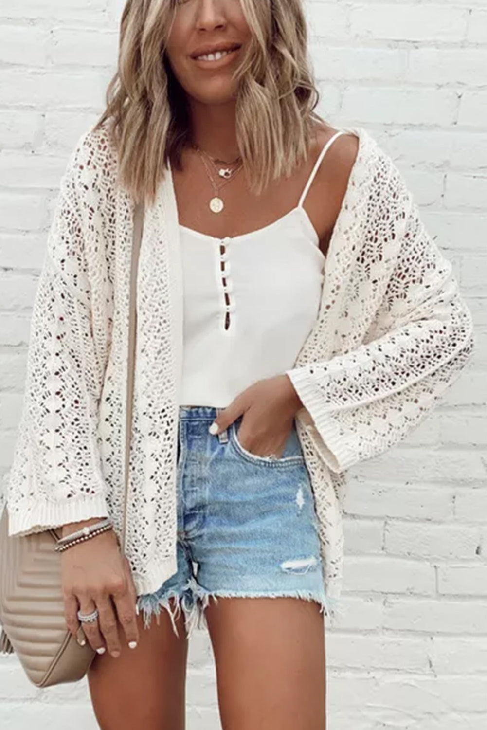 Chic white knit cardigan with hollow out details and drop shoulder design