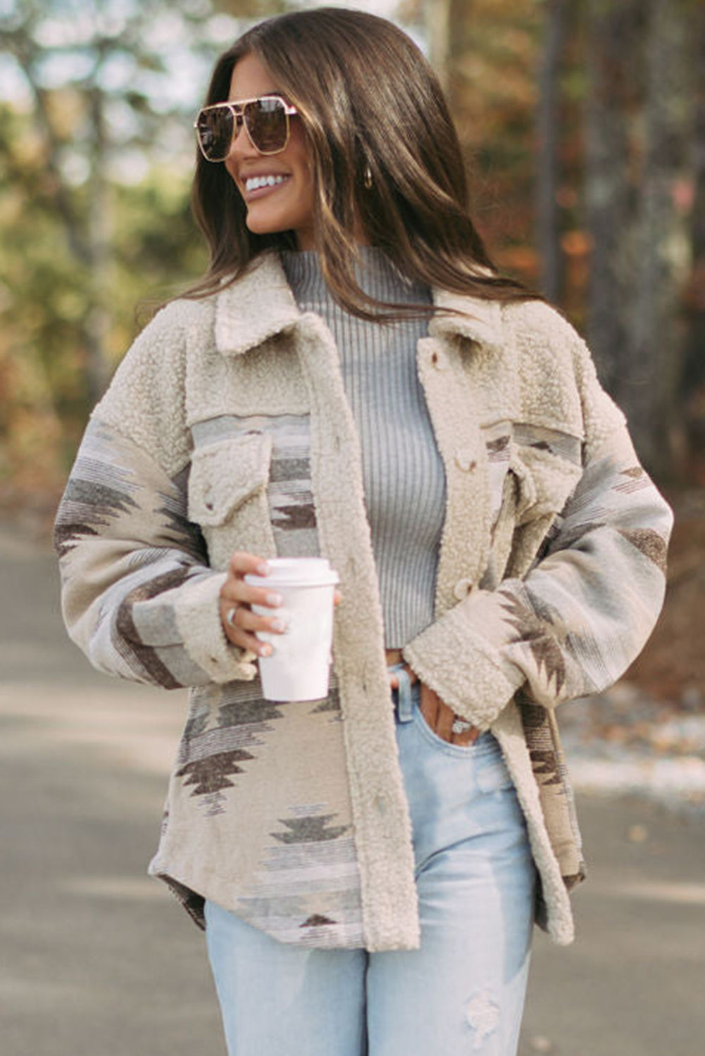 Khaki sherpa coat with vibrant Aztec print and flap pockets