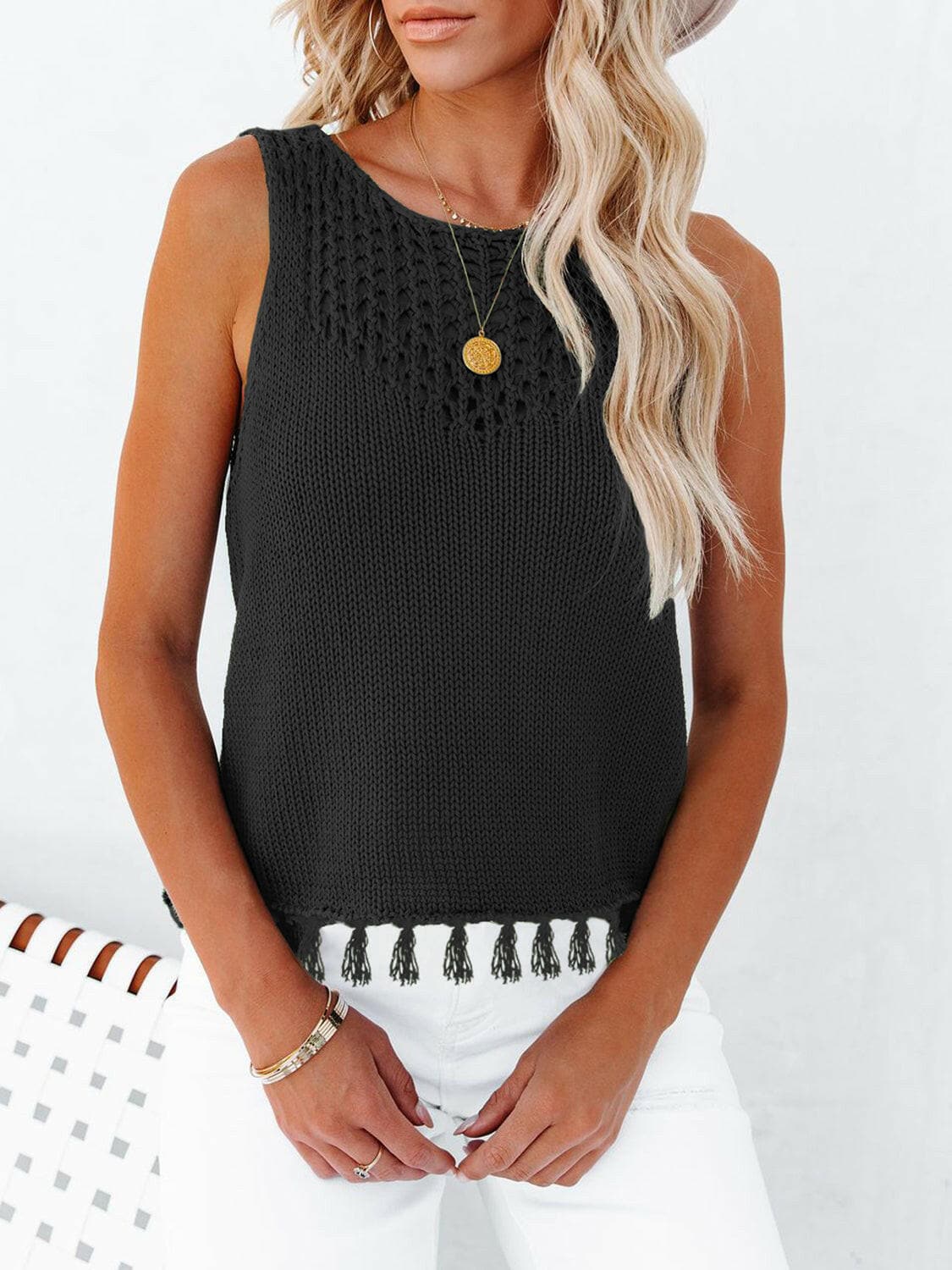 Chic cutout tank with tassels, featuring a round neck and semi-sheer fabric.