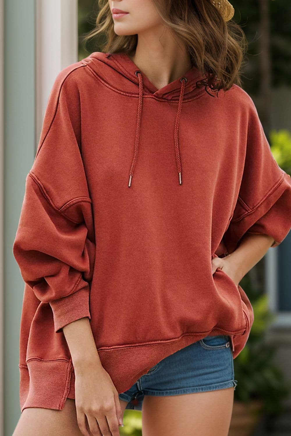 Casual chic dropped shoulder hoodie in rust, high-low design, opaque, no stretch, polyester-cotton blend.