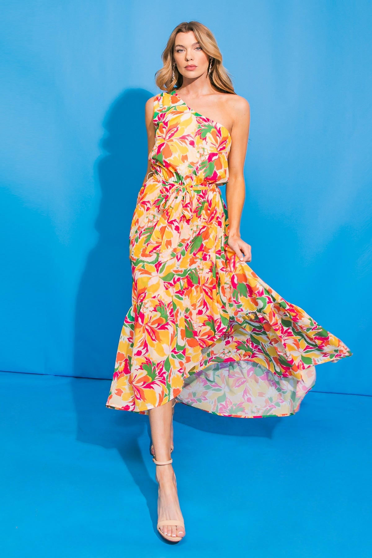 Floral one-shoulder hi-lo maxi dress with ruffled hem and self sash tie.