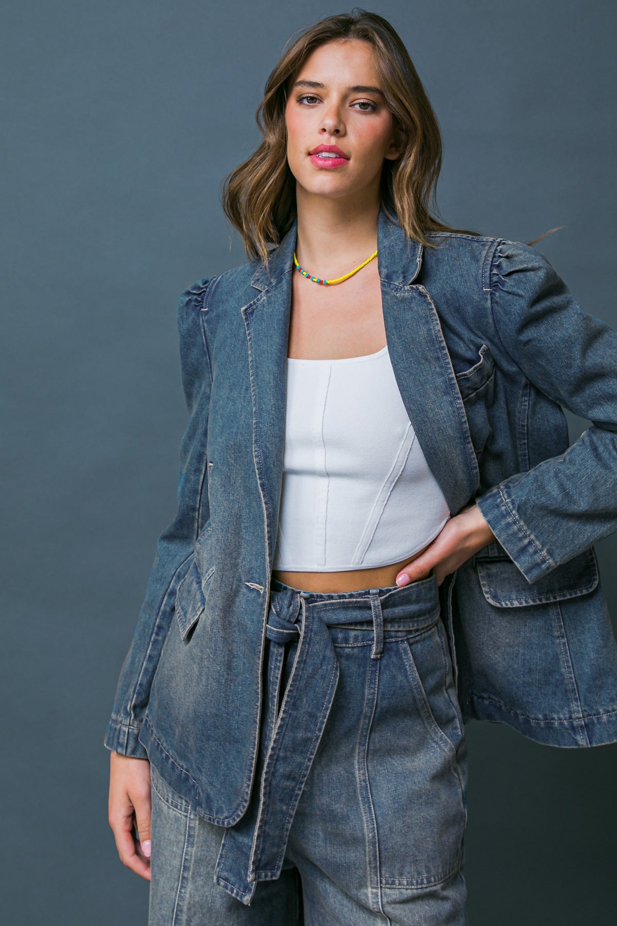 Woman wearing the GIVE IT YOUR ALL denim blazer with matching pants.