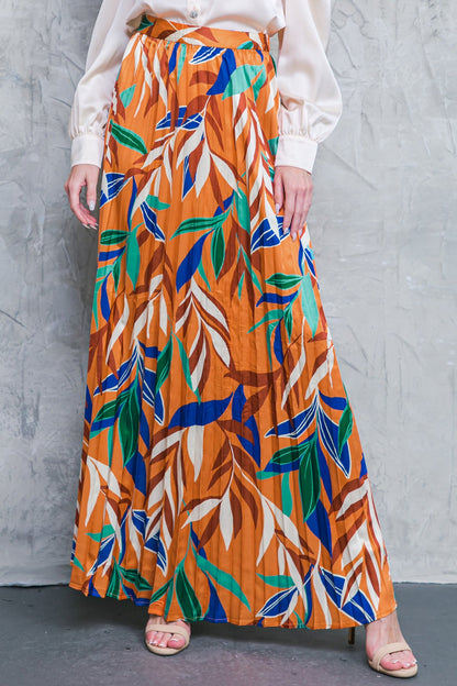 Boho-style fall woven maxi skirt with a colorful leaf pattern and pleated design.