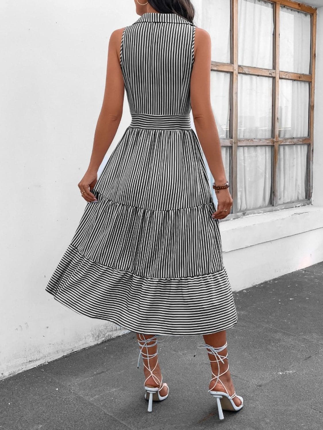 Chic striped midi dress with collar and decorative buttons.