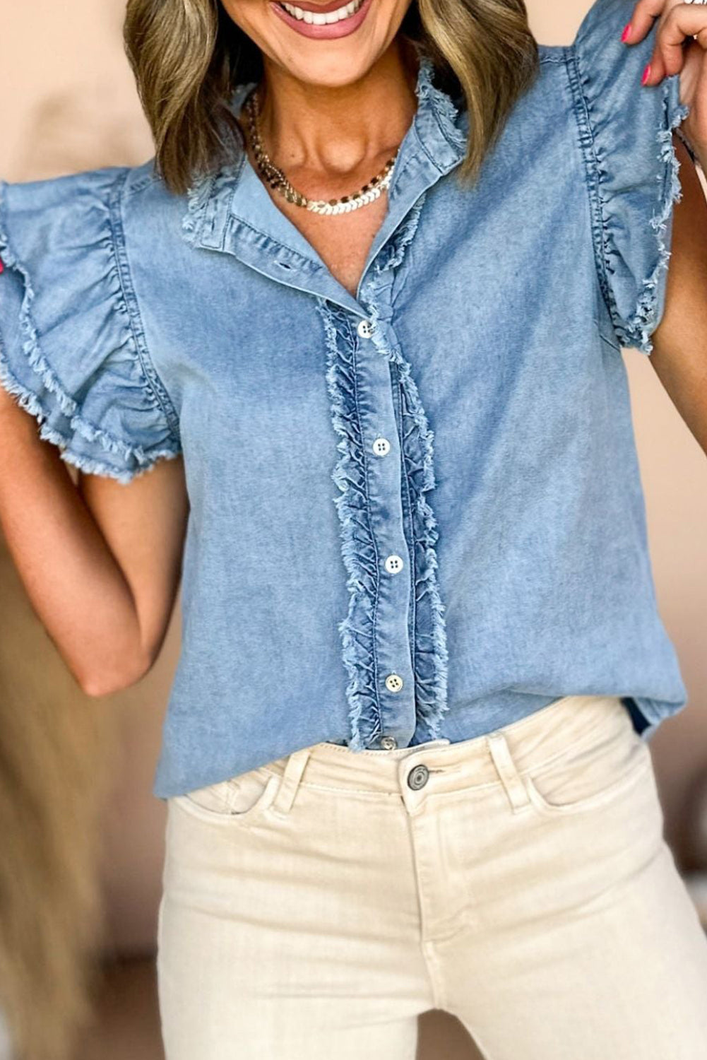 Chic ruffled denim top with button front and frayed hem