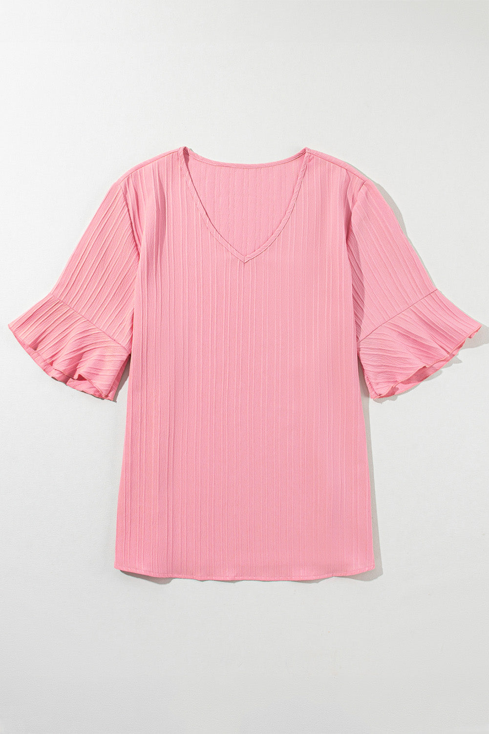 Peach blossom textured plus top with ruffled sleeves and V-neck