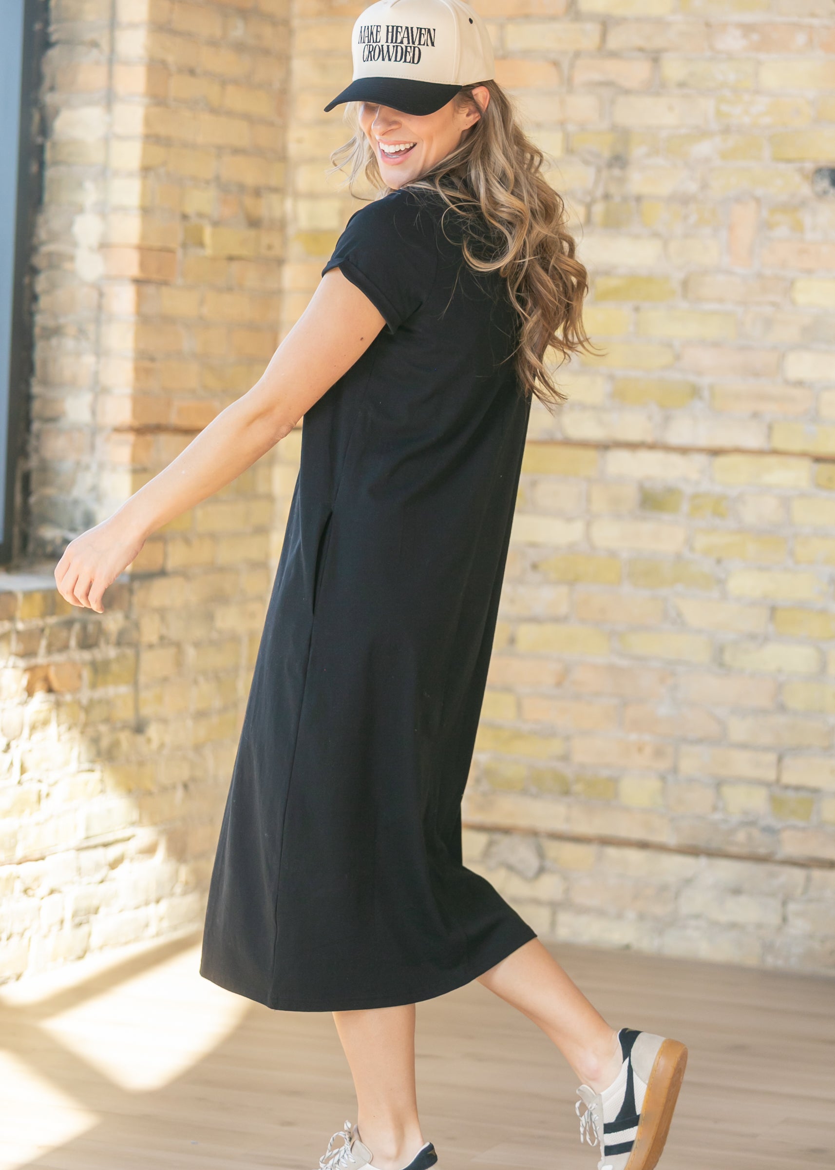 Back view of the Inherit Co. Finley V-neck T-shirt Dress on a model, highlighting its smooth drape and relaxed comfortable fit.