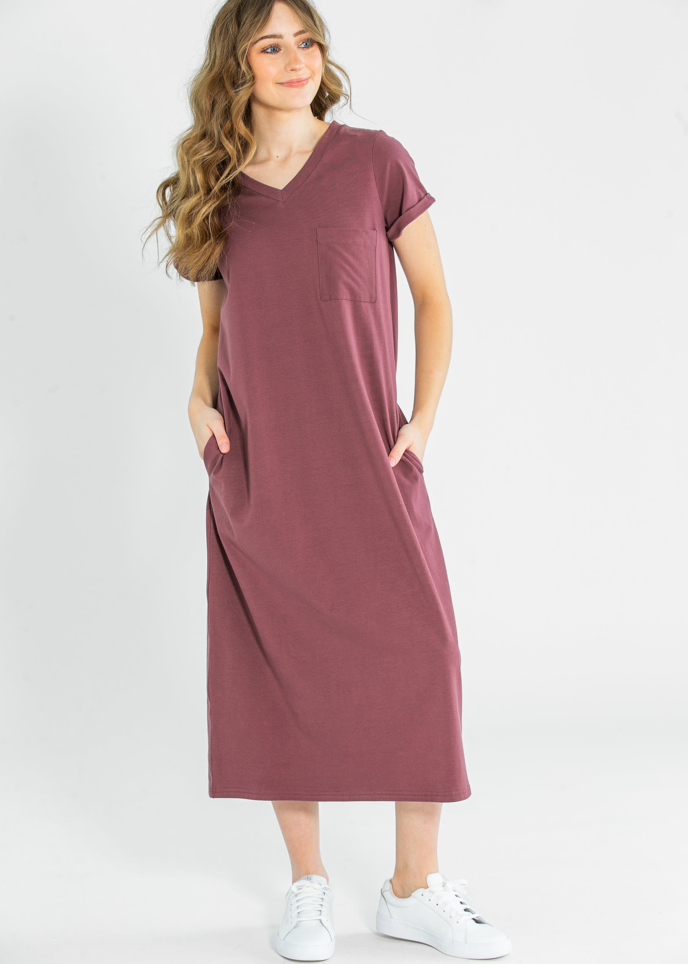 Model relaxing in the Inherit Co. Finley V-neck T-shirt Dress, showcasing its ultimate comfort and relaxed everyday style.