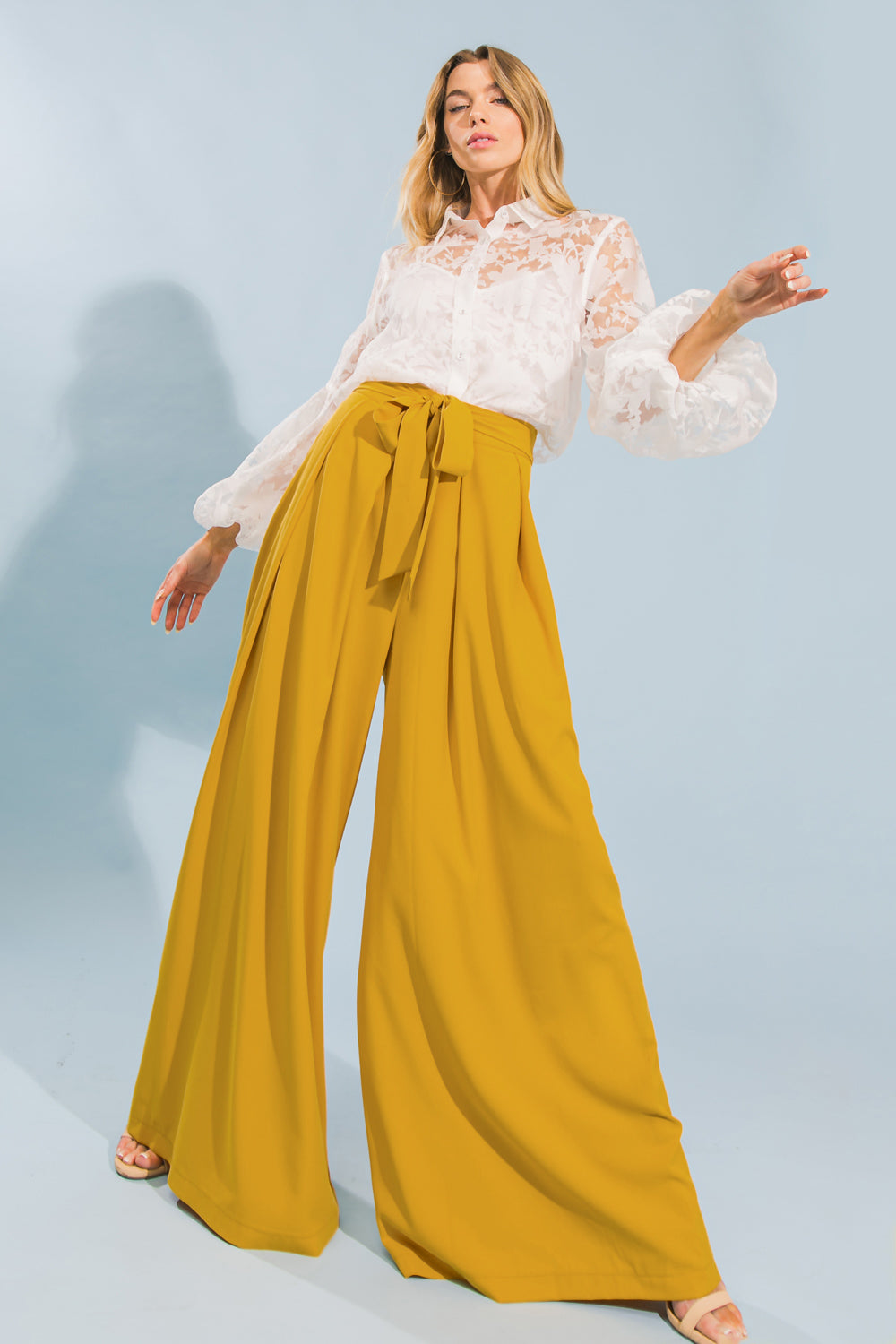 Wide-leg woven pants with inverted pleats, self sash tie, and side zipper closure for a sophisticated look.