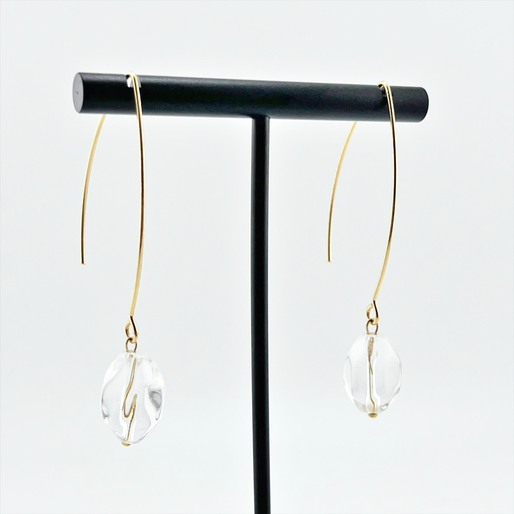 Close-up of a single Katia Designs Small Stone Drop Earring, showcasing the intricate natural stone texture and subtle gold-plated setting.